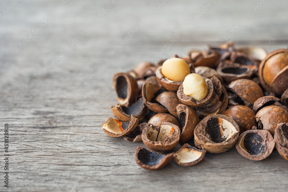Pile of peeled Macadamia nuts on wooden table Pile of peeled Macadamia nuts on wooden table