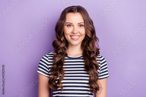 Photo of pretty sweet young lady wear striped t-shirt smiling isolated purple color background