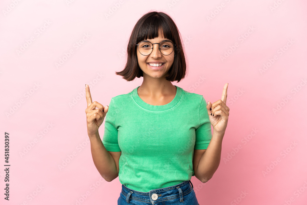 Young mixed race woman isolated on pink background pointing up a great idea Young mixed race woman isolated on pink background pointing up a great idea