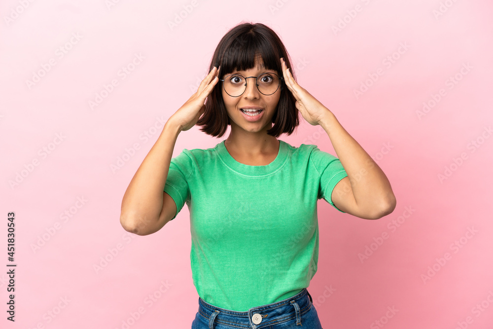 Young mixed race woman isolated on pink background with surprise expression Young mixed race woman isolated on pink background with surprise expression
