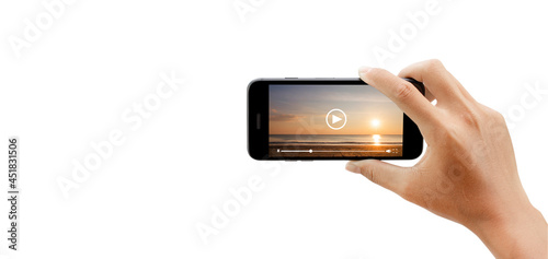 watching video of sunset beach by mobile phone isolated on white background. clipping paths.