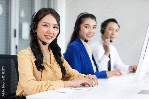 portrait woman operator wearing headphones for working at call center service