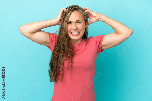 Young caucasian woman isolated on blue background doing nervous gesture