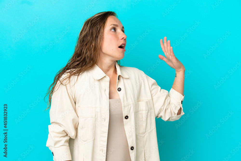 Young caucasian woman isolated on blue background with tired and sick expression Young caucasian woman isolated on blue background with tired and sick expression