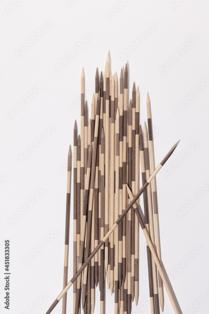 Japanese Board game Mikado. Bamboo sticks from the game on a white background. Top view, macro Japanese Board game Mikado. Bamboo sticks from the game on a white background. Top view, macro