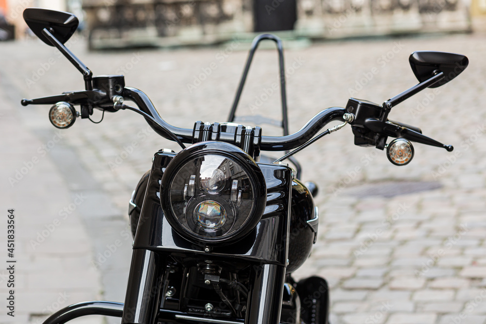 Fototapeta premium Part of a retro black motorcycle with a large headlight