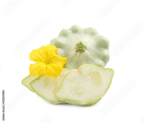 Whole and cut pattypan squashes with flower on white background