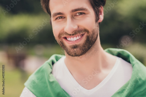 Cropped photo of young handsome cheerful man beard happy positive toothy smile sunny weather season outdoors