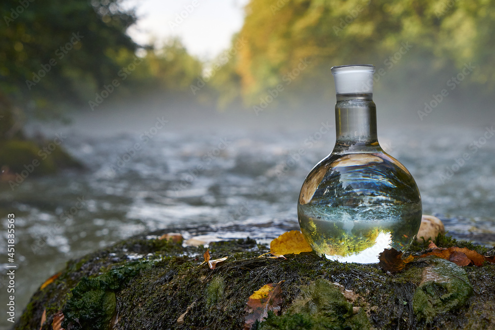 Flask with clear river water.