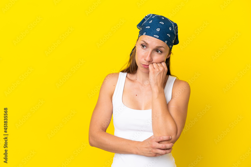 Young English woman isolated on yellow background with tired and bored expression