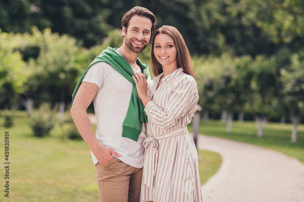 Photo of young cheerful couple boyfriend girlfriend happy positive smile cuddle date romantic walk park outdoors Photo of young cheerful couple boyfriend girlfriend happy positive smile cuddle date romantic walk park outdoors