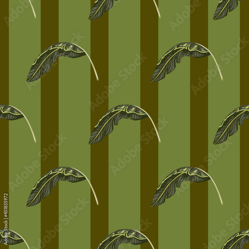 Seamless pattern with tropical leaves decorative ornament. Pale green striped background. Simple style. photo