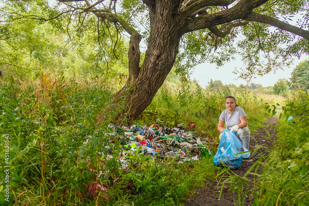 woman clean up garbage dump in the park. woman clean up garbage dump in the park.