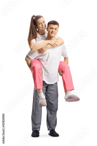 Guy in pajamas carrying a girl on a piggyback