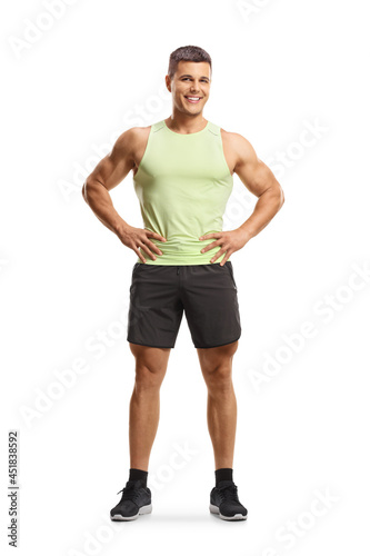 Fit young man in sportswear smiling at camera