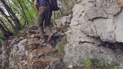 person climbing on a rock