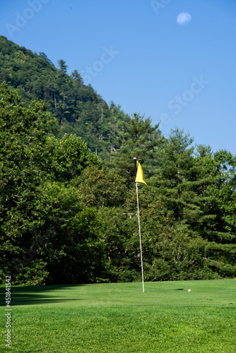 Flag and Golf Ball, With the Moon Overhead