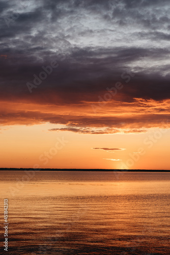 Photo of a Summer Sunset on the Lake. Travel location of popular tourist outdoor. View of beautiful Sea Landscape. Relax vacation near water © Nik