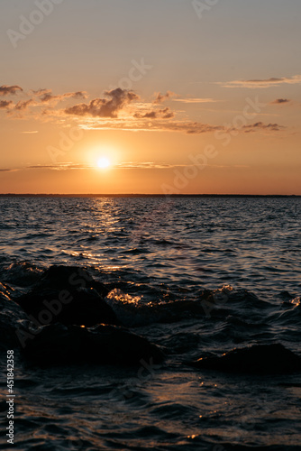 Photo of a Summer Sunset on the Lake. Travel location of popular tourist outdoor. View of beautiful Sea Landscape. Relax vacation near water