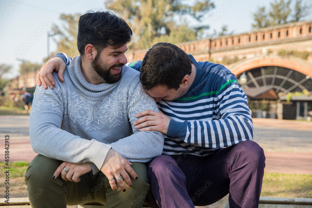 Happy gay couple sharing a romantic embrace outdoors. Happy gay couple sharing a romantic embrace outdoors.