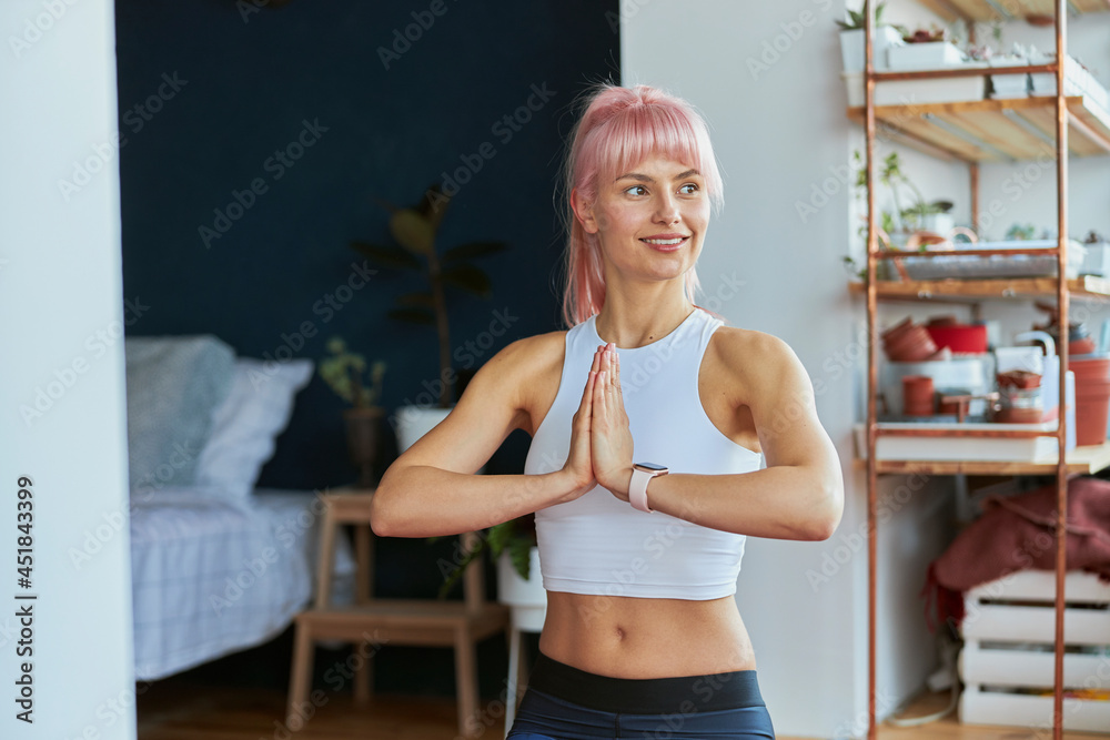 Yoga practitioner does namaste mudra by hands during home training on balcony Yoga practitioner does namaste mudra by hands during home training on balcony
