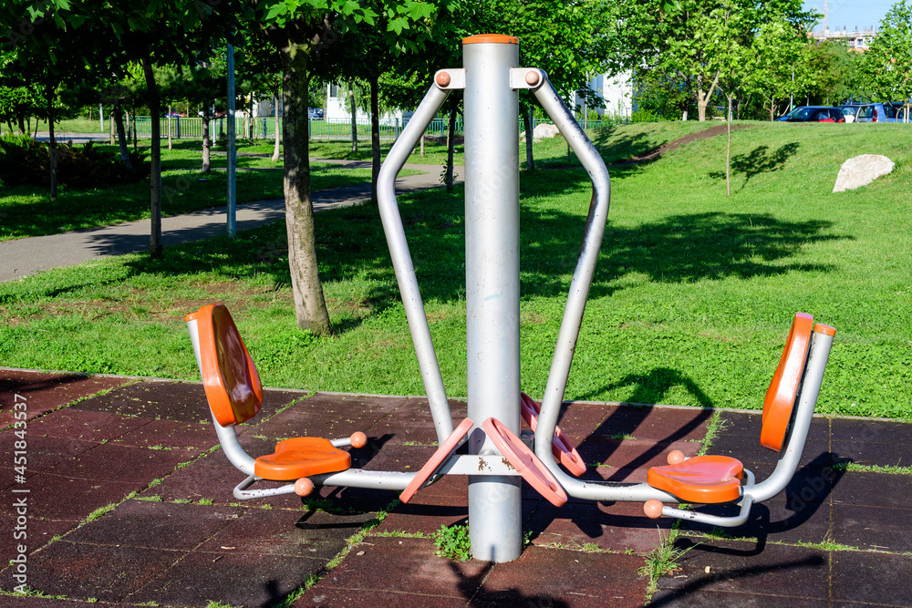 Outdoors fitness device machine in a city park for sport and activities, in a sunny spring day, in Bucharest, Romania .