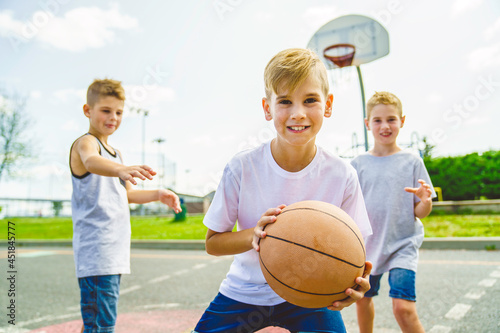 Young Boys brother Playing Basketball on the summer time
