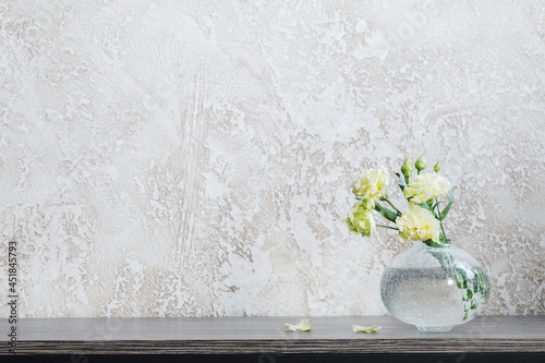 Fototapeta Naklejka Na Ścianę i Meble -  yellow eustoma in  glass vase on table