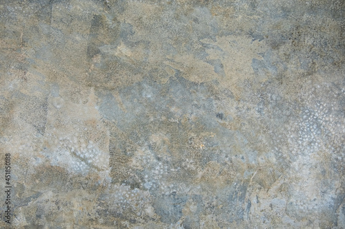Plastered grey wall surface as a seamless background.