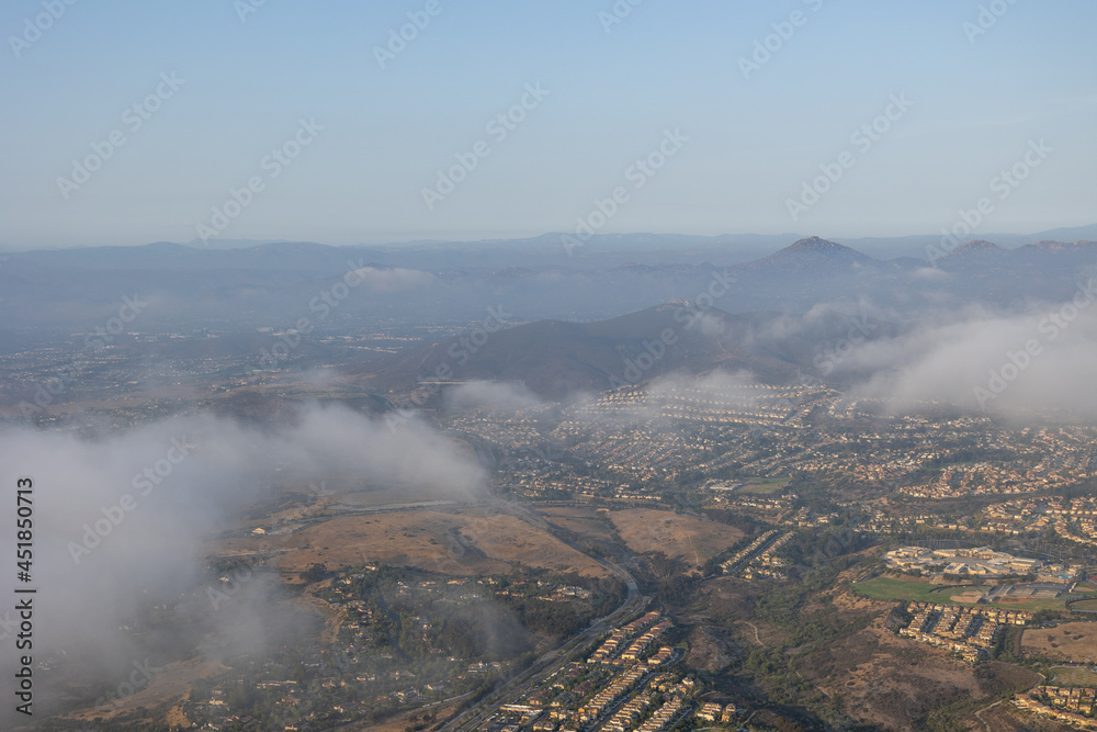 Aerial view over the cloud of Carmel Valley with suburban neighborhood San Diego, California, USA. Aerial view over the cloud of Carmel Valley with suburban neighborhood San Diego, California, USA.