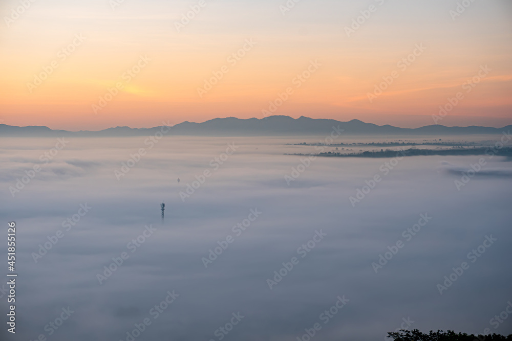 Morning fog covers Lamphun, Thailand, view from the viewpoint of Wat Phra That Pha Temple