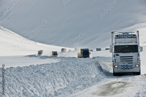 Trucks driving on the snow-covered No 1 road in Iceland photo