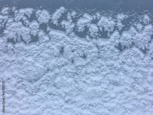 winter white snow covered wall. gray spots are visible through background for the label.