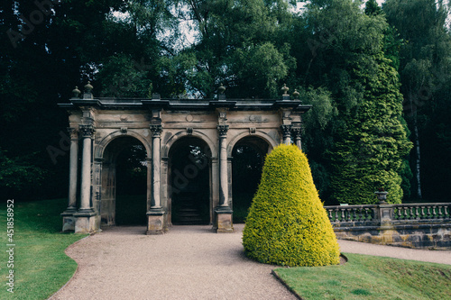 Scenic view of an old, medieval building with arch passages in Trentham Gardens photo