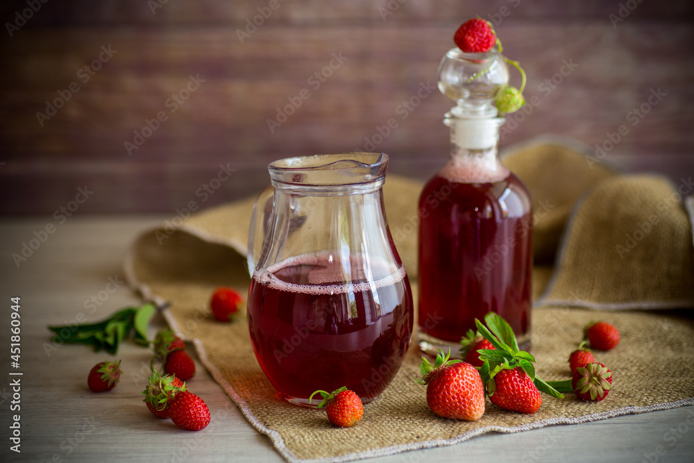 sweet cooked strawberry syrup in a glass decanter sweet cooked strawberry syrup in a glass decanter