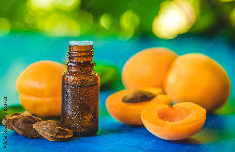 Apricot kernel oil in a bottle. Selective focus. Apricot kernel oil in a bottle. Selective focus.