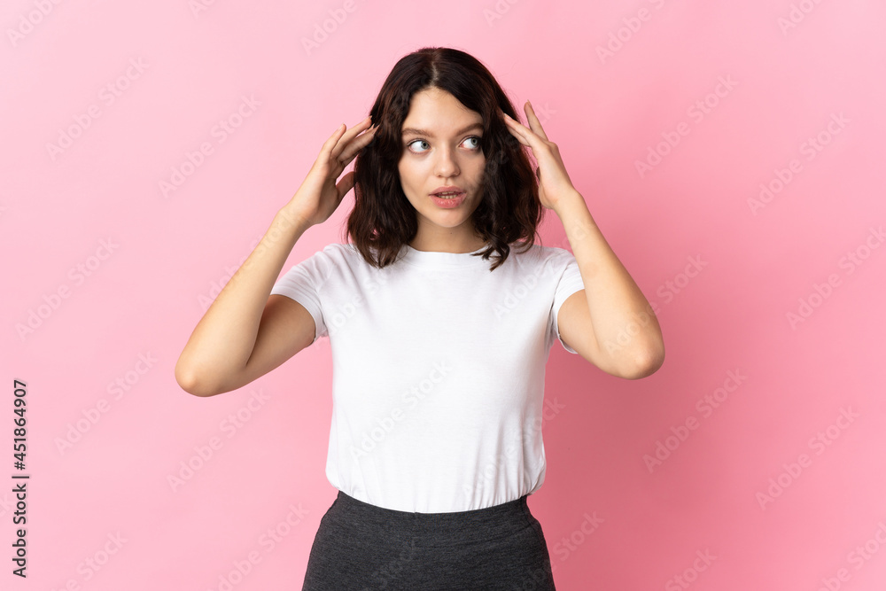 Teenager Ukrainian girl isolated on pink background having doubts and thinking Teenager Ukrainian girl isolated on pink background having doubts and thinking