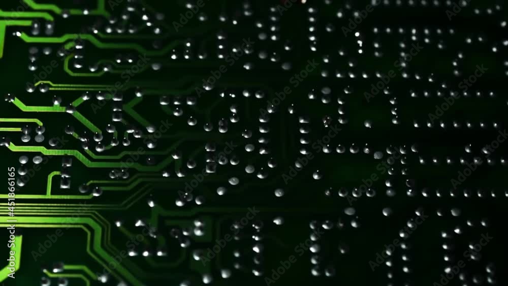 Printed Circuit Board along which a beam of light green moves. Macro. Closeup Printed Circuit Board along which a beam of light green moves. Macro. Closeup