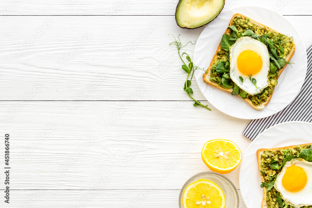 Open sandwich with eggs and avocado on plate. Overhead view Open sandwich with eggs and avocado on plate. Overhead view