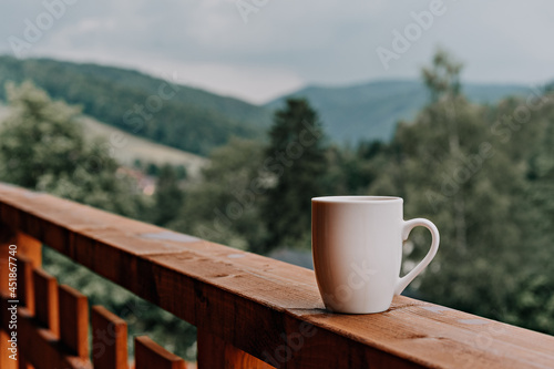 White mug on the terrace in the mountains