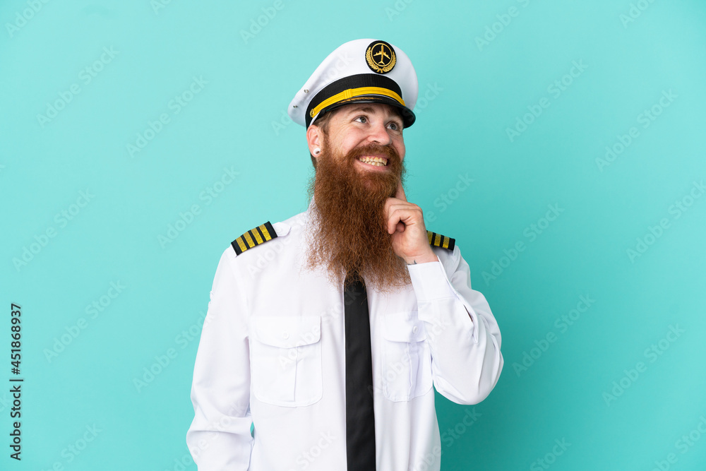 Redhead caucasian man playing rugby isolated on yellow background thinking an idea while looking up Redhead caucasian man playing rugby isolated on yellow background thinking an idea while looking up