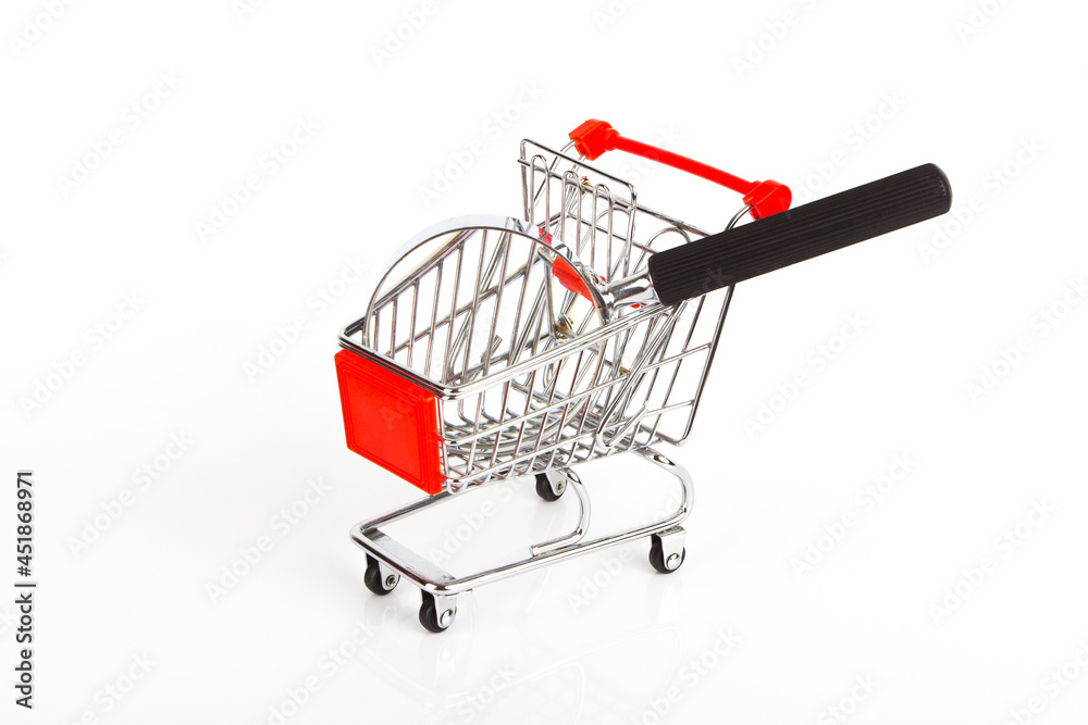 Magnifying glass in the shopping cart on the white glossy background