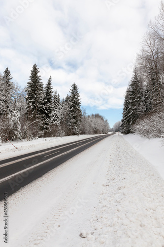 paved road covered with snow in winter