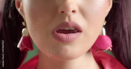 Beautiful young woman chewing gum, closeup