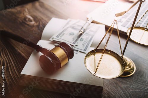 Business and lawyers discussing contract papers with brass scale on desk in office. Law, legal services, advice, justice and law concept picture with film grain effect