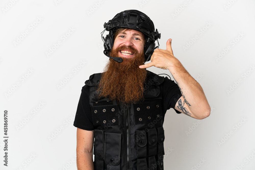 Redhead SWAT isolated on white background making phone gesture. Call me back sign Redhead SWAT isolated on white background making phone gesture. Call me back sign