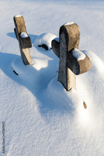 old stone crosses in the winter season