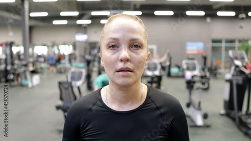 a middle-aged woman works out in the gym on a treadmill to lose excess weight. healthy lifestyle