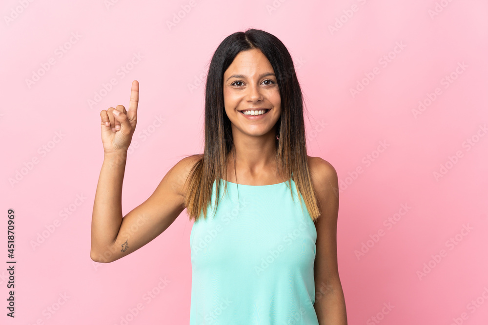 Caucasian girl isolated on pink background pointing up a great idea Caucasian girl isolated on pink background pointing up a great idea