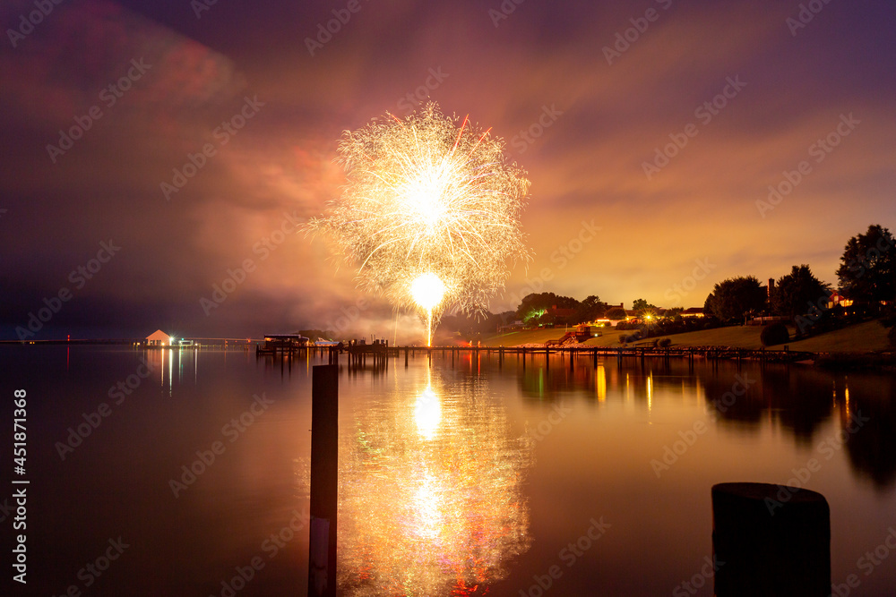 Fireworks over the river and reflected in the water Fireworks over the river and reflected in the water